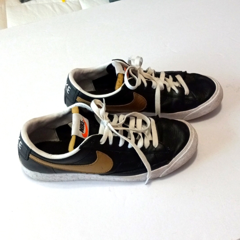 Nike Black Leather with Gold trim Size US 9.5. Gold swoosh.